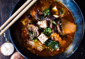 shiitake mushrooms, silken tofu and kale. Serve over rice or noodles! Delicious Korean flavor! #kimchisoup #easykimchisoup #vegankimchisoup #plantbased #cleaneating #eatclean #vegansoup #koreansoup