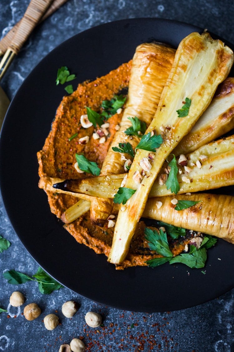 Roasted Parsnips with Romesco Sauce, a simple vegan side dish that is perfect for weeknight dinners or the holiday table! #vegan #veganside #sidedish #healthyside #parsnips #parsniprecipe #roastedparships