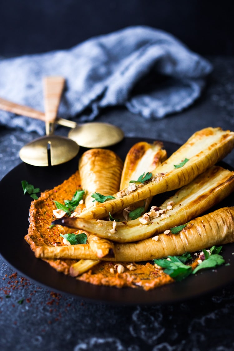 Roasted Parsnips with Romesco Sauce, a simple vegan side dish that is perfect for weeknight dinners or the holiday table! #vegan #veganside #sidedish #healthyside #parsnips #parsniprecipe #roastedparships