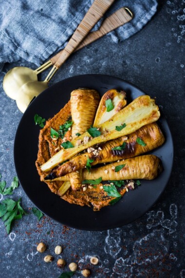 Roasted Parsnips with Romesco Sauce, a simple vegan side dish or plant-based Main dish that is perfect for weeknight dinners or the holiday table! #vegan #veganside #sidedish #healthyside #parsnips #parsniprecipe #roastedparships