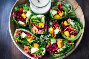 Vegan collard greens wraps are filled with hummus, crispy tofu, shredded beets, carrots and avocado! Drizzle with Tahini sauce! A delicious healthy lunch! #eatclean #cleaneating #vegan #veganlunch #rainbowwrap #Wraps #veganwrap #plantbased #collardgreens