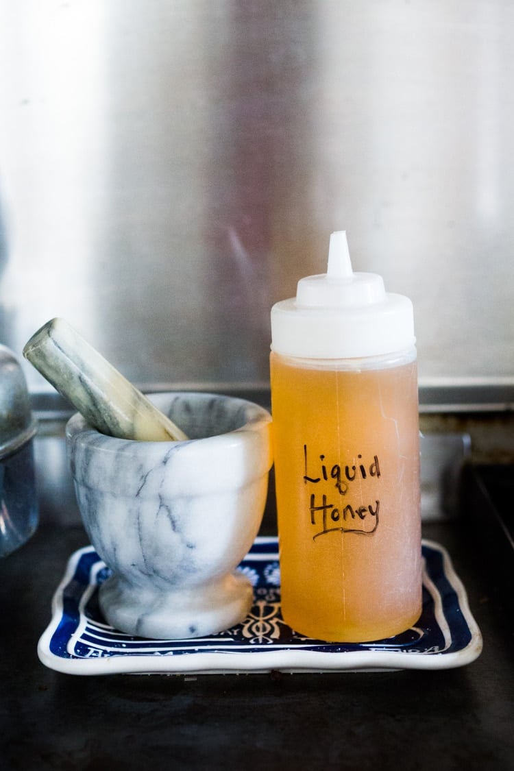How to make Honey Simple Syrup - an easy way to revive old honey or keep honey loose and liquid so it's easy to pour and mix into vinaigrettes, marinades and drinks! #honeysimplesyrup #liquidhoney #honey #alternativesweetener #eatingclean #cleaneating #eatclean