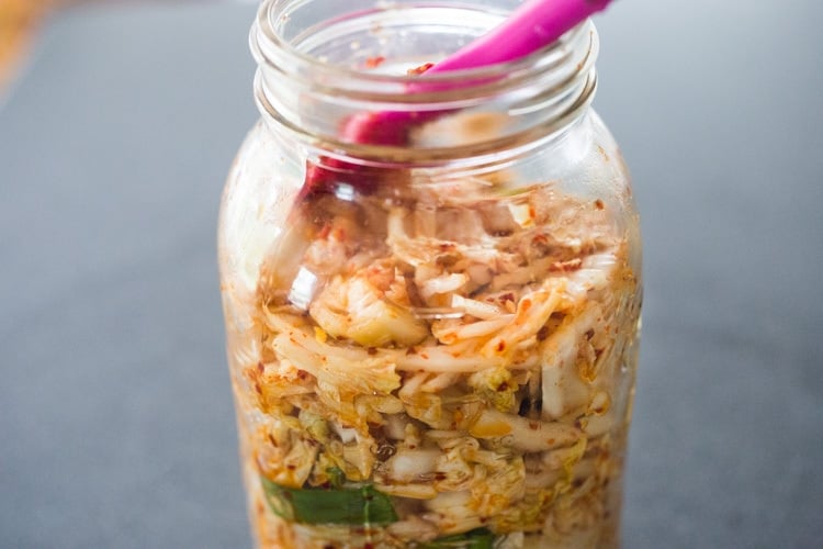 packing the kimchi in a jar. 