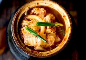 This Kimchi Recipe is quick and easy and takes only  30 minutes of hands-on time before mother nature takes over! Full of healthy, gut-healing probiotics, the benefits of eating kimchi are endless. This authentic kimchi is vegan-adaptable, gluten-free and can be made as spicy or as mild as you like!