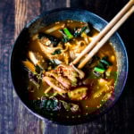 A simple easy recipe for Kimchi Soup- this version is vegan, made with shiitake mushrooms, silken tofu and kale. Serve over rice or noodles! Delicious Korean flavor! #kimchisoup #easykimchisoup #vegankimchisoup #plantbased #cleaneating #eatclean #vegansoup #koreansoup