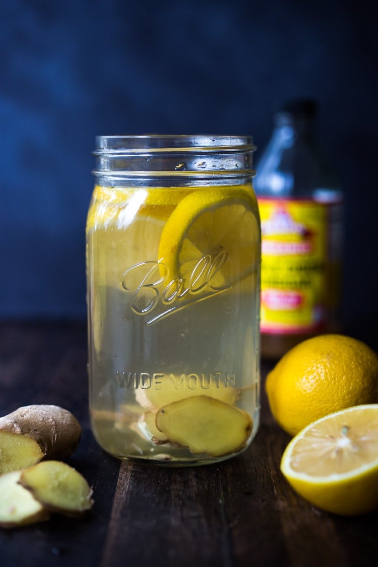 How to make a switchel- a healthy, energizing, probiotic drink made with apple cider vinegar (with the "mother" in it) lemon, ginger, sweetened with honey or maple to aid the gut, lower cholesterol, shed weight, boost immunity, help with digestion and regularity and increase energy! #switchel #switzel #probiotics #guthealth #healthydrinks #healthygut #healthybacteria #detox #cleaneating #eatclean #applecidervinegar #drink #water #ginger