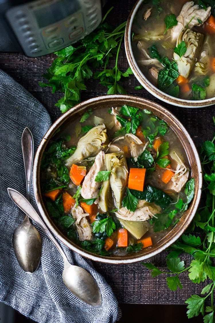 Instant Pot Chicken Artichoke Soup with Wild Rice - a light, healthy and brothy soup with vegetables, wild rice and artichoke sauce with only 15 minutes of hands on time! A quick and easy dinner recipe! #chickensoup #chickenwildricesoup #instantpotrecipe #instantpotsouprecipe #brothbasedsoup #artichokesoup #easysoup #easydinner #ketosoup