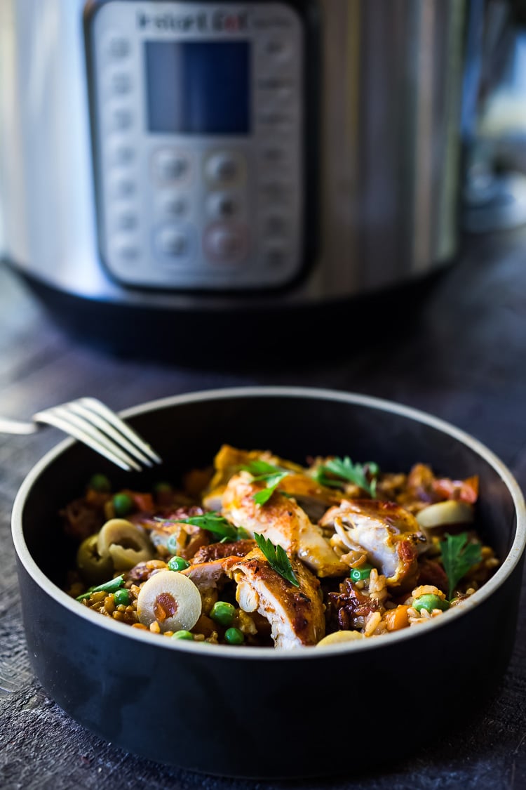 Instant Pot Arroz con Pollo - made in a fraction of the time! This Spanish version is infused with saffron and smoked paprika and full of amazing flavor! #instantpotchicken #instantpotrecipes #spanishchicken #easydinners #ArrozconPollo