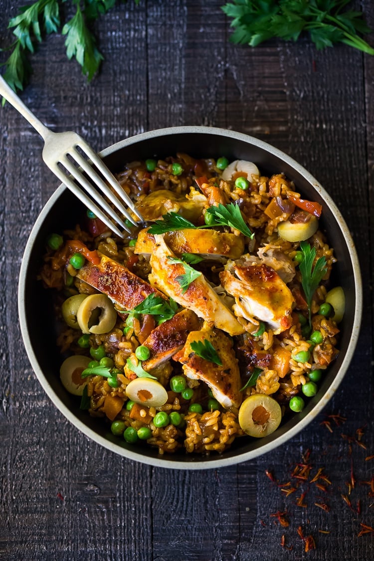 Instant Pot Arroz con Pollo - made in a fraction of the time! This Spanish version is infused with saffron and smoked paprika and full of amazing flavor! #instantpotchicken #instantpotrecipes #spanishchicken #easydinners #ArrozconPollo