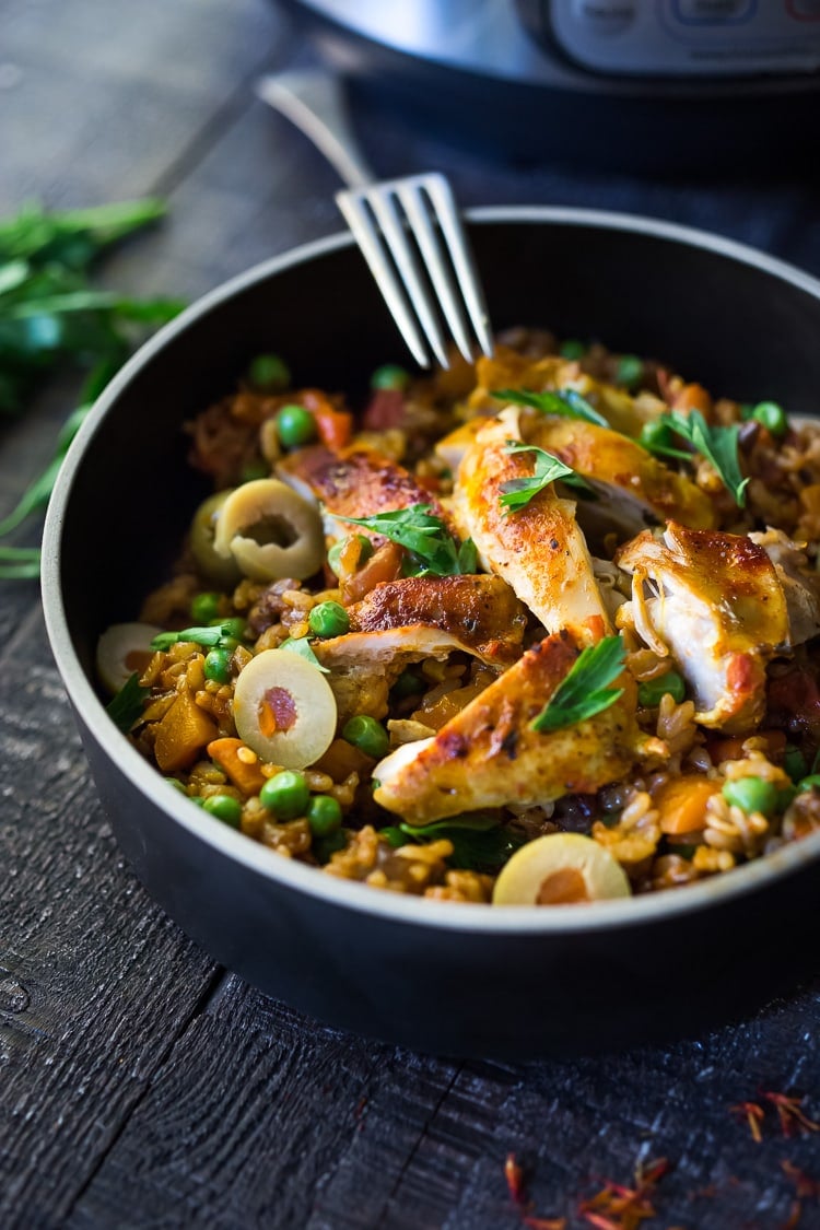 Instant Pot Arroz con Pollo - made in a fraction of the time! This Spanish version is infused with saffron and smoked paprika and full of amazing flavor! #instantpotchicken #instantpotrecipes #spanishchicken #easydinners #ArrozconPollo