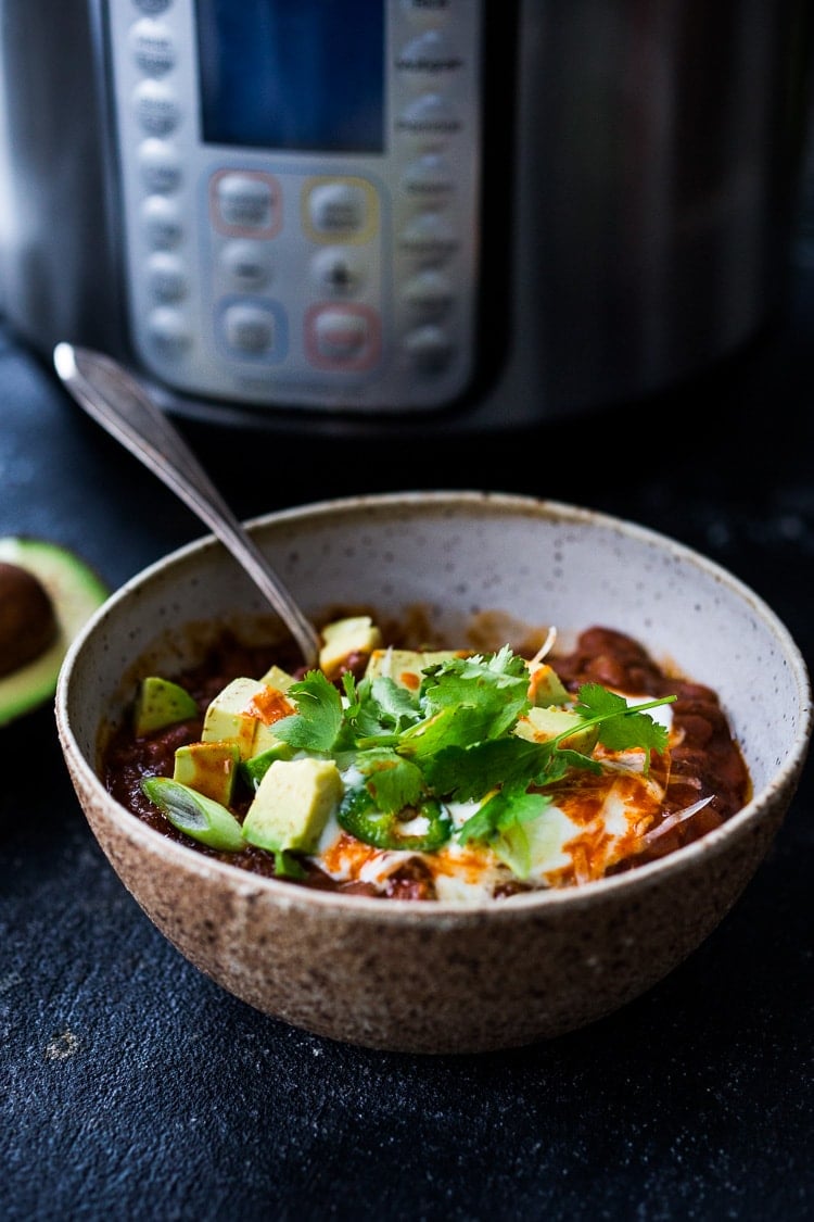 Chili in a bowl with Instant pot in background. 