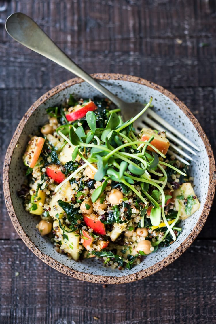 Winter Happiness Salad! Kale & Quinoa Salad with Apples, Chickpeas and Currants! A hearty vegan salad that can be made ahead- perfect for potlucks, gatherings or midweek lunches! #kalesalad #vegansalad #quinoasalad #chickpeasalad #healthysalad #potluck