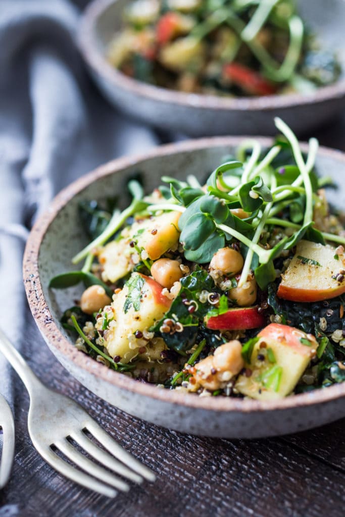 Winter Happiness Salad! Kale & Quinoa Salad with Apples, Chickpeas and Currants! A hearty vegan salad that can be made ahead- perfect for potlucks, gatherings or midweek lunches! #kalesalad #vegansalad #quinoasalad #chickpeasalad #healthysalad #potluck