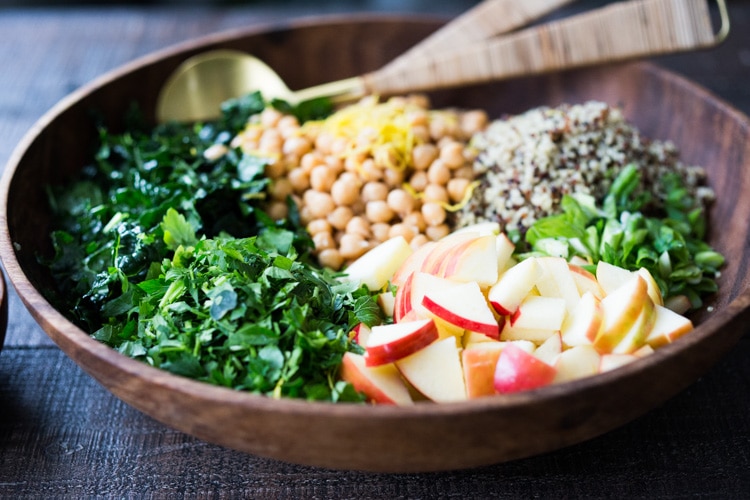 Kale Quinoa Salad with Apples, Chickpeas and Currants! A hearty vegan salad that can be made ahead- perfect for potlucks, gatherings or midweek lunches! #kalesalad #vegansalad #quinoasalad #chickpeasalad #healthysalad #potluck