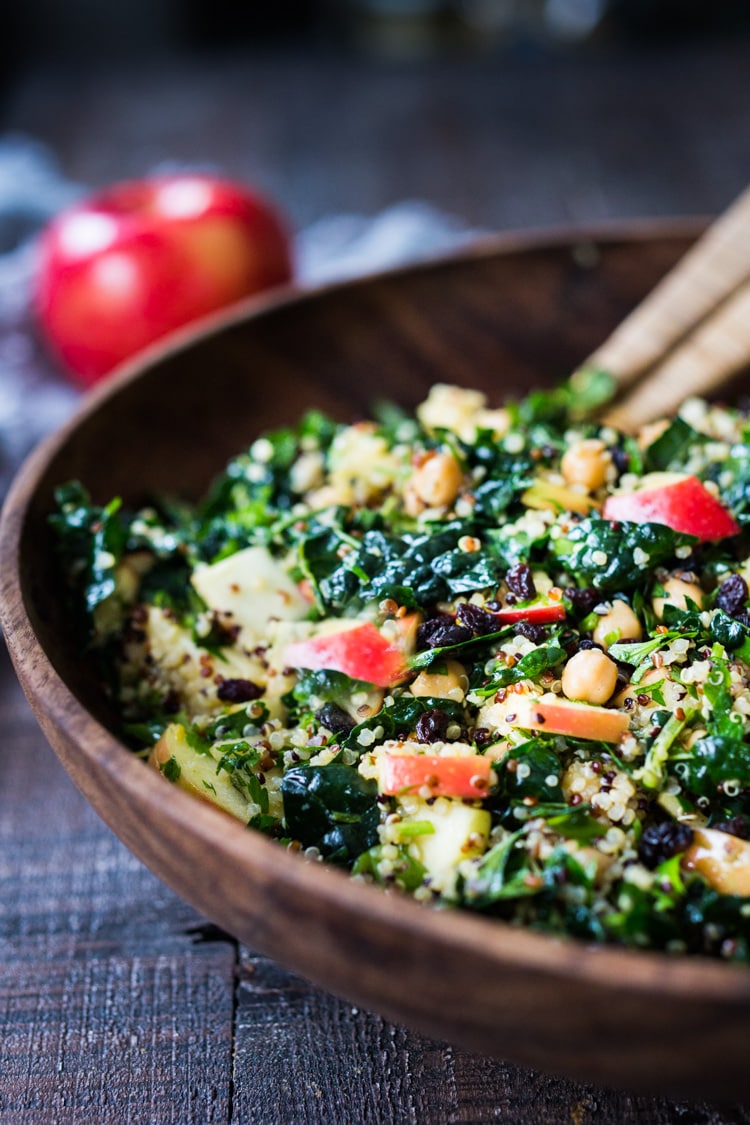 Kale Quinoa Salad with Apples, Chickpeas and Currants! A hearty vegan salad that can be made ahead- perfect for potlucks, gatherings or midweek lunches! #kalesalad #vegansalad #quinoasalad #chickpeasalad #healthysalad #potluck