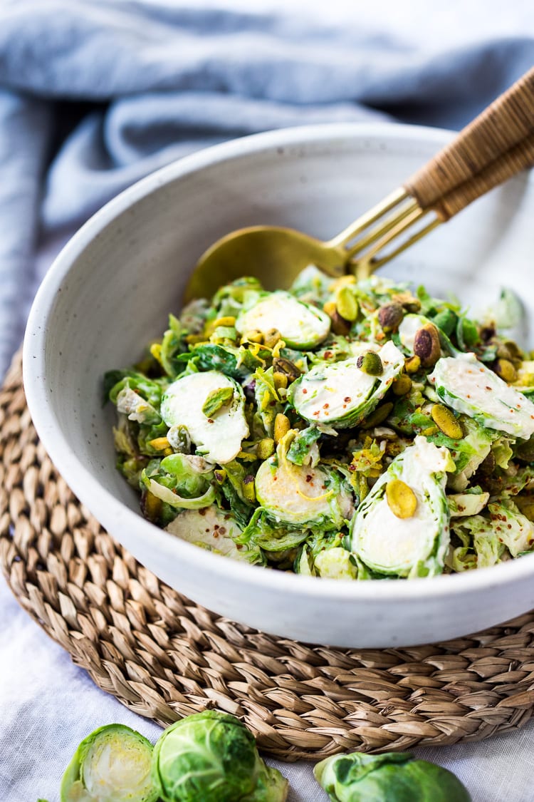 Lemony Brussel Sprout Salad with Tahini Sauce and Pistachios - a tasty, vegan salad that can be made ahead. Perfect for midweek lunches or potlucks or gatherings. #brusselsprouts #brusselsproutsalad #brusselsproutslaw #brusselsproutsrecipes #vegan #plantbased #cleaneating #eatclean #vegansalad 