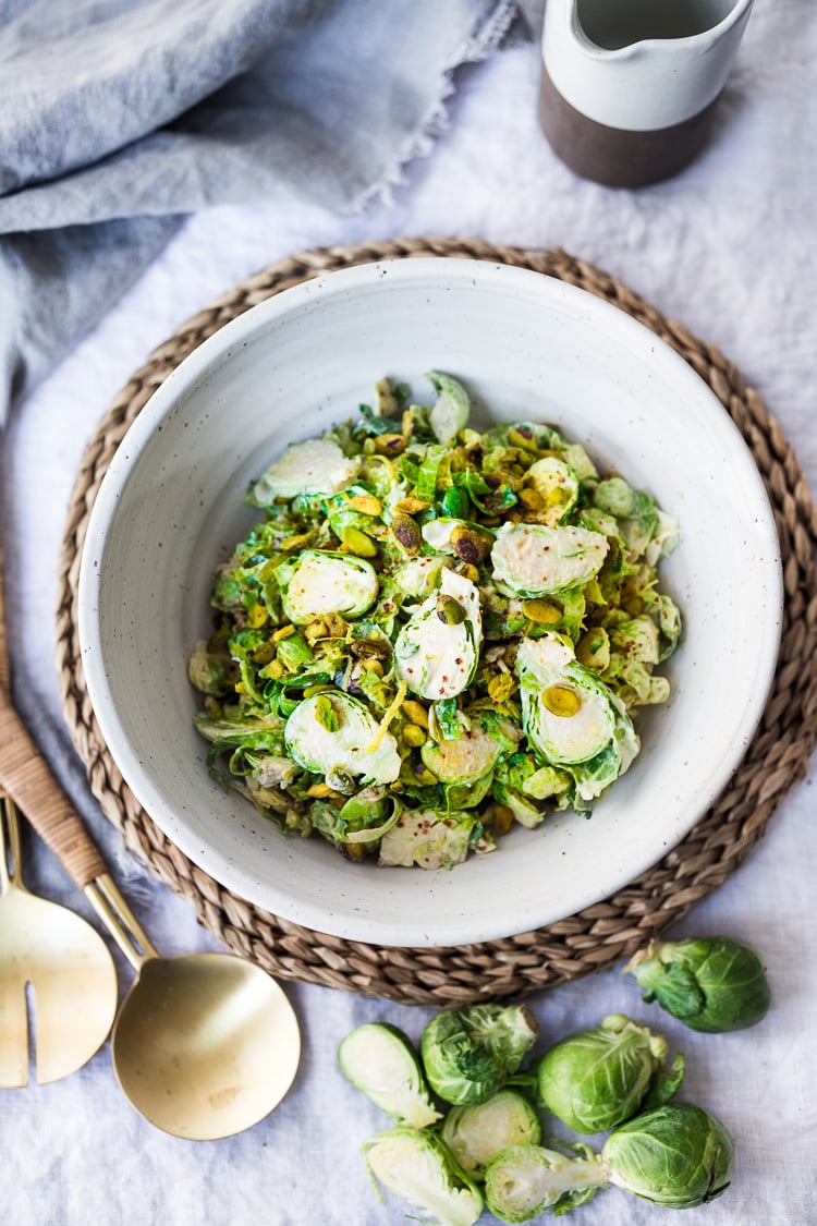 Lemony Brussel Sprout Salad with Creamy Tahini Sauce and Pistachios - a tasty, vegan salad that can be made ahead. Perfect for midweek lunches or potlucks or gatherings. #brusselsprouts #brusselsproutsalad #brusselsproutslaw #brusselsproutsrecipes #vegan #plantbased #cleaneating #eatclean #vegansalad 