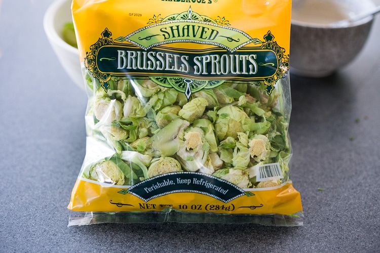 Lemony Brussel Sprout Salad with Creamy Tahini Sauce and Pistachios - a tasty, vegan salad that can be made ahead. Perfect for midweek lunches or potlucks or gatherings. #brusselsprouts #brusselsproutsalad #brusselsproutslaw #brusselsproutsrecipes #vegan #plantbased #cleaneating #eatclean #vegansalad 