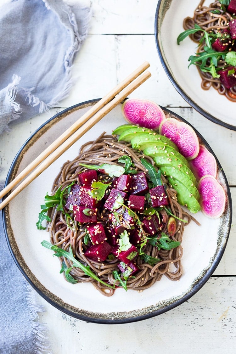 Delicious Vegan Poke Bowls made with Beet Poke- made with steamed beets instead of fish, this marinated beet salad can be made ahead and served over rice, greens or noodles. Vegan and GF adaptable! Includes a Video. #poke #beetsalad #beets #avocado #soba #pokebowl #vegansalad #cleaneating