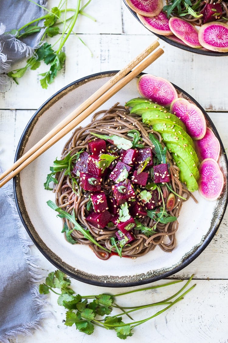 Delicious Vegan Poke Bowls made with Beet Poke- made with steamed beets instead of fish, this marinated beet salad can be made ahead and served over rice, greens or noodles. Vegan and GF adaptable! Includes a Video. #poke #beetsalad #beets #avocado #soba #pokebowl #vegansalad #cleaneating