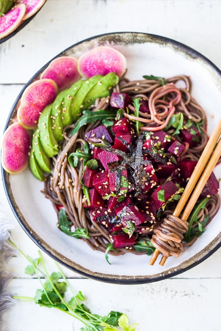 Delicious Vegan Poke Bowls made with Beet Poke- made with steamed beets instead of fish, this marinated beet salad can be made ahead and served over rice, greens or noodles. Vegan and GF adaptable! Includes a Video. #poke #beetsalad #beets #avocado #soba #pokebowl #vegansalad #cleaneating