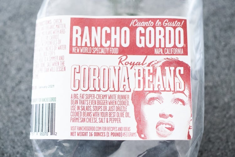 Corona Beans- giant buttery white beans seasoned with olive oil, garlic, fresh herbs and lemon zest. Serve as a vegan main or side dish or add to salads and Buddha Bowls. #corona #beans #whitebeans #Gigantes #royalcoronabeans