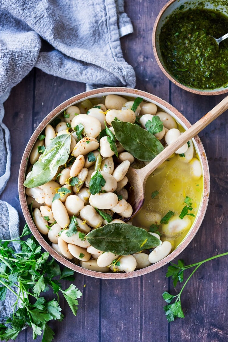 Corona Beans- giant buttery white beans seasoned with olive oil, garlic, fresh herbs and lemon zest. Serve as a vegan main or side dish or add to salads and Buddha Bowls. #corona #beans #whitebeans #Gigantes #royalcoronabeans