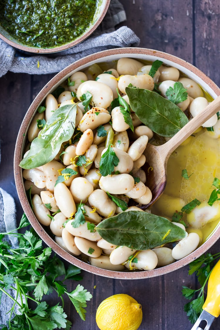 Corona Beans- giant buttery white beans seasoned with olive oil, garlic, fresh herbs and lemon zest. Serve as a vegan main or side dish or add to salads and Buddha Bowls. #corona #beans #whitebeans #Gigantes #royalcoronabeans 