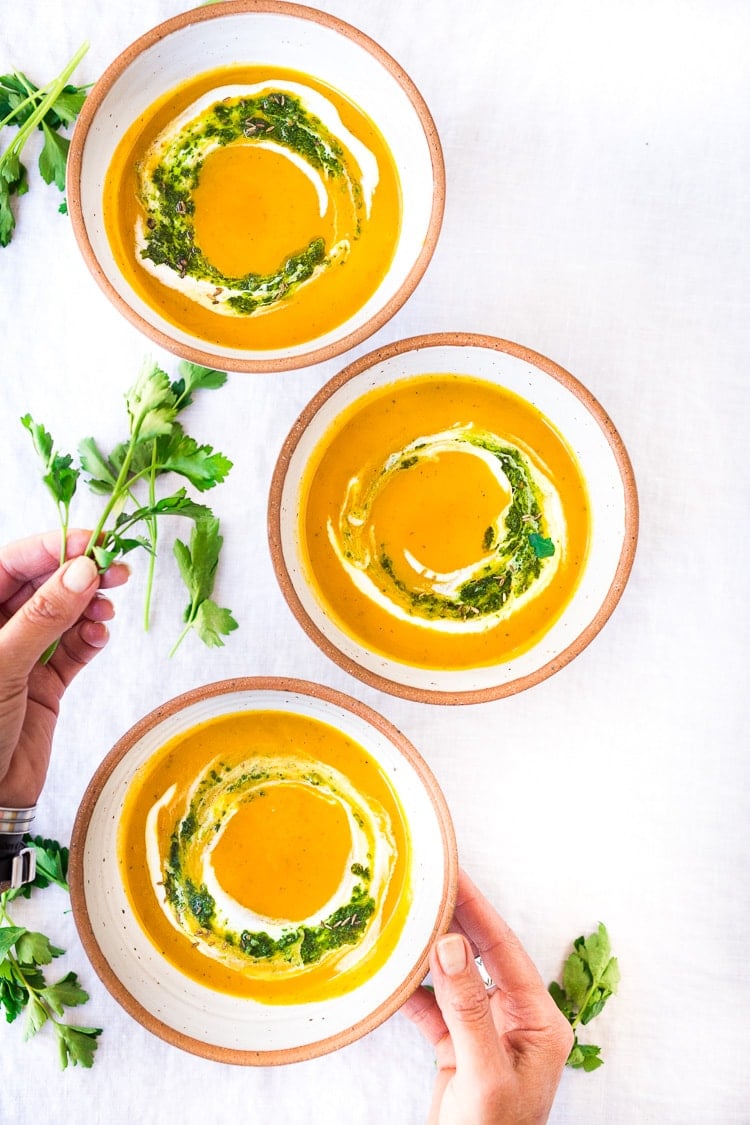 Carrot Soup with Chermoula and North African Spices - a simple healthy soup bursting with flavor. Vegan Adaptable! #carrotsoup #carrots #vegan #chermoula