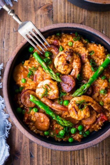 This delicious Jambalaya Recipe is full of flavor, depth, and complexity- yet lightened up with chicken sausage and seasonal, healthy veggies. This can be made in an Instant Pot or on the Stovetop!  A delicious weeknight dinner. Vegan-adaptable.