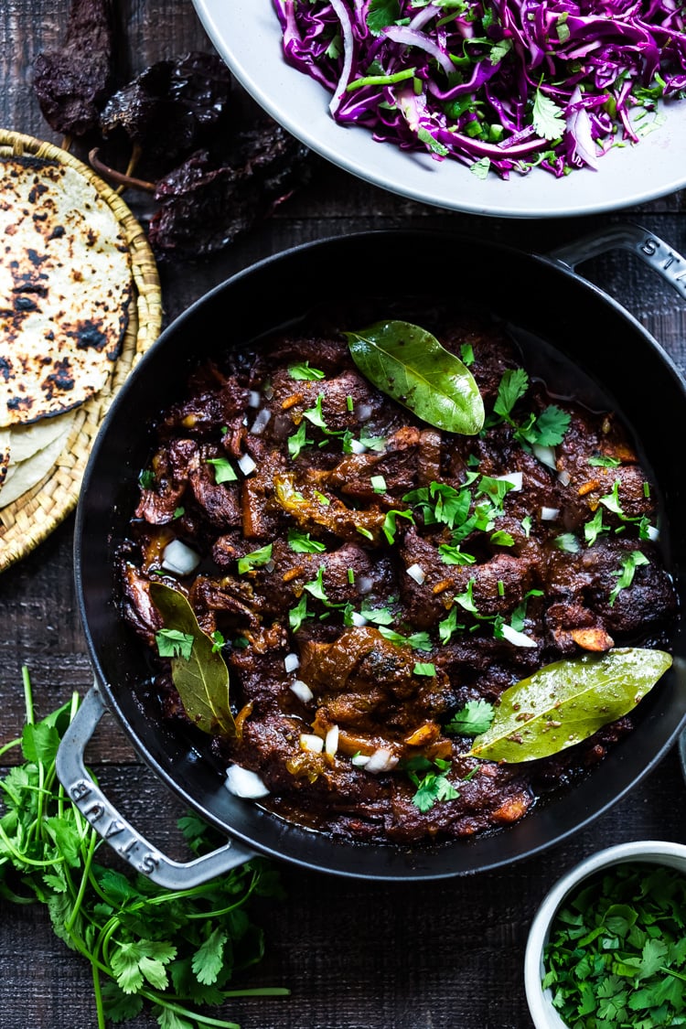 Mexican Lamb Barbacoa - a simple delicious recipe from Oaxaca that results in tender, juicy falling off the bone lamb perfect for tacos and burritos! #tacos #barbacoa #lamb #lambrecipes #oaxaca #mexicanrecipes #cincodemayo 