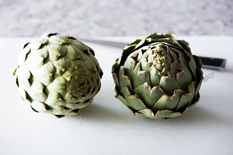 Roasted Artichokes with Lemony Leek dressing - a healthy vegan way to cook and serve our favorite spring vegetable! #artichoke #artichokes #bakedartichokes #roastedartichokes #vegan #veganartichokesauce 