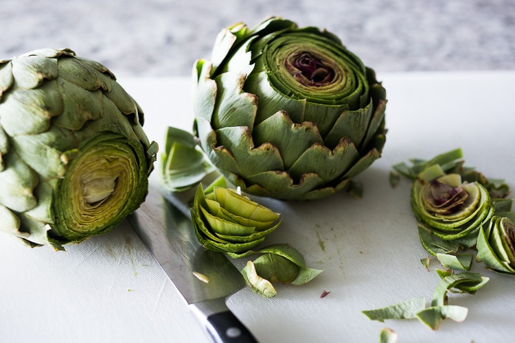 How to roast Artichokes! Roasted Artichokes with Lemony Leek dressing - a healthy vegan way to cook and serve our favorite spring vegetable! #artichoke #artichokes #bakedartichokes #roastedartichokes #vegan #veganartichokesauce 