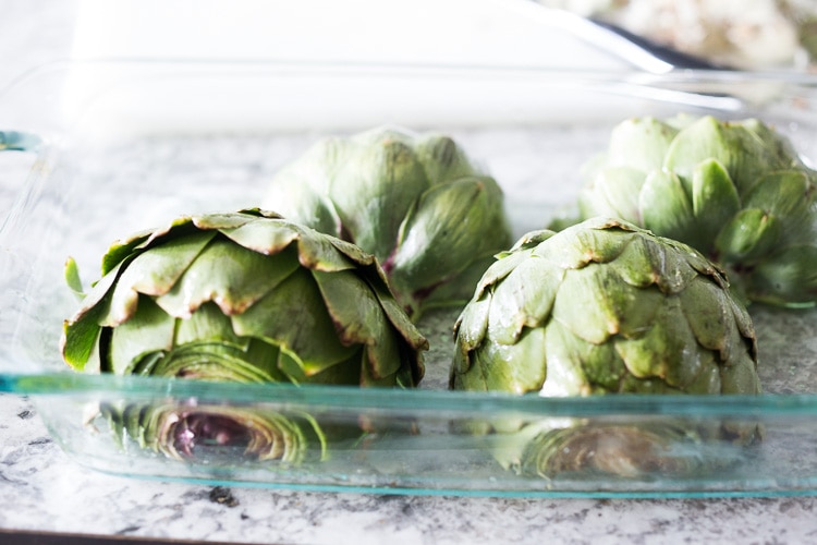 How to roast Artichokes! Roasted Artichokes with Lemony Leek dressing - a healthy vegan way to cook and serve our favorite spring vegetable! #artichoke #artichokes #bakedartichokes #roastedartichokes #vegan #veganartichokesauce 