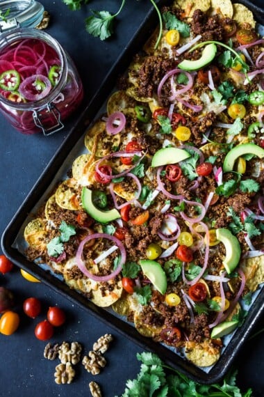 Nachos Supreme! These loaded vegetarian nachos are made with flavorful "walnut chorizo"! A healthy, delicious nacho recipe that is baked in the oven. Vegan-adaptable and Gluten free! #nachos #vegannachos #vegetarian