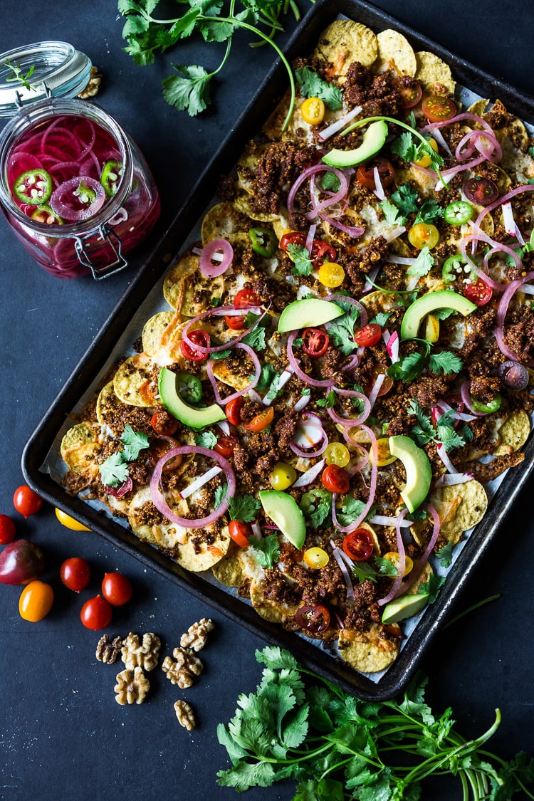 Nachos Supreme! These loaded vegetarian nachos are made with flavorful "walnut chorizo"! A healthy, delicious nacho recipe that is baked in the oven. Vegan-adaptable and Gluten free! #nachos #vegannachos #vegetarian 