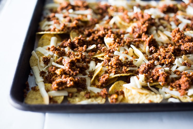 Nachos Supreme! These loaded vegetarian nachos are made with flavorful "walnut chorizo"! A healthy, delicious nacho recipe that is baked in the oven. Vegan-adaptable and Gluten free! #nachos #vegannachos #vegetarian 