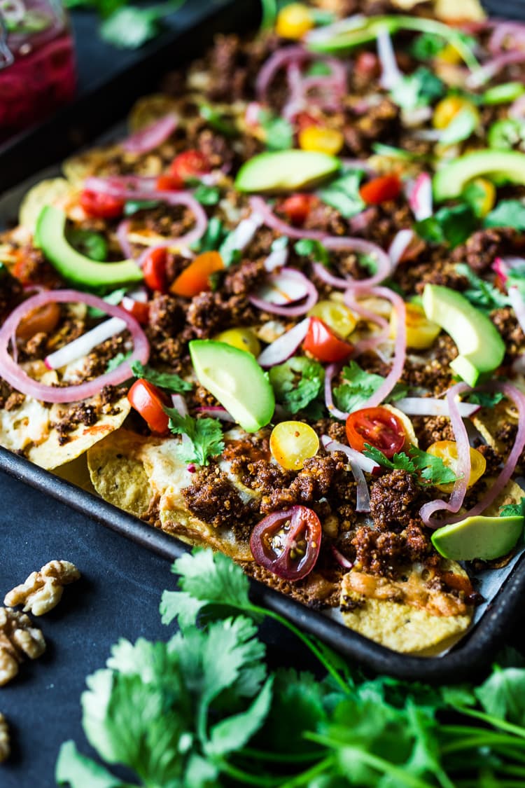 Nachos Supreme! These loaded vegetarian nachos are made with flavorful "walnut chorizo"! A healthy, delicious nacho recipe that is baked in the oven. Vegan-adaptable and Gluten free! #nachos #vegannachos #vegetarian 