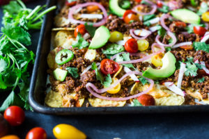 Nachos Supreme! These loaded vegetarian nachos are made with flavorful "walnut chorizo"! A healthy, delicious nacho recipe that is baked in the oven. Vegan-adaptable and Gluten free! #nachos #vegannachos #vegetarian