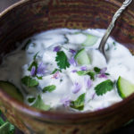 A delicious Raita Recipe- an Indian yogurt sauce with cucumber, mint and cilantro. Cooling and refreshing, serve this with spicy Indian dishes to cool the palate. #raita #yogurtsauce #cucumberraita #indianrecipes
