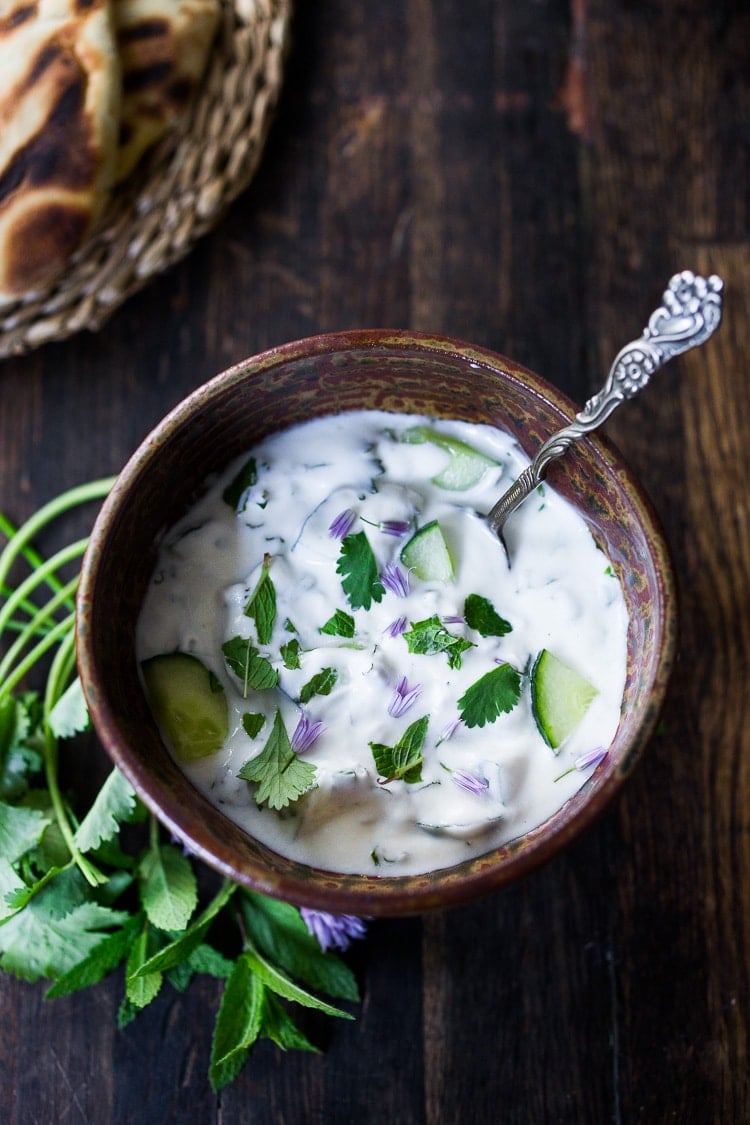 A delicious Raita Recipe- an Indian yogurt sauce with cucumber, mint and cilantro. Cooling and refreshing, serve this with spicy Indian dishes to cool the palate. #raita #yogurtsauce #cucumberraita #indianrecipes 