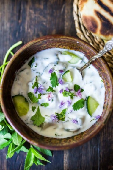 An authentic recipe for Raita- a creamy Indian yogurt sauce with cucumber, mint and cilantro. Cooling and refreshing, serve this with spicy Indian dishes to help cool the palate. Video Plus  35+ Mouthwatering Indian Recipes to Make at Home!