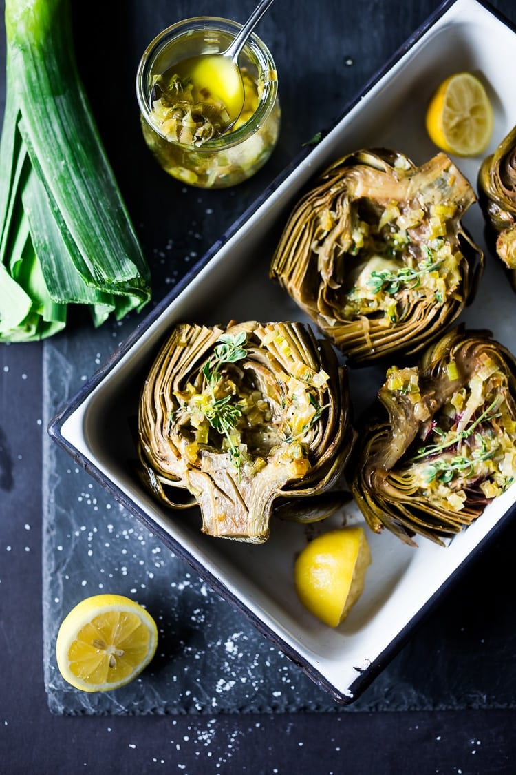 Roasted Artichokes with Lemony Leek dressing - a healthy vegan way to cook and serve our favorite spring vegetable! #artichoke #artichokes #bakedartichokes #roastedartichokes #vegan #veganartichokesauce 