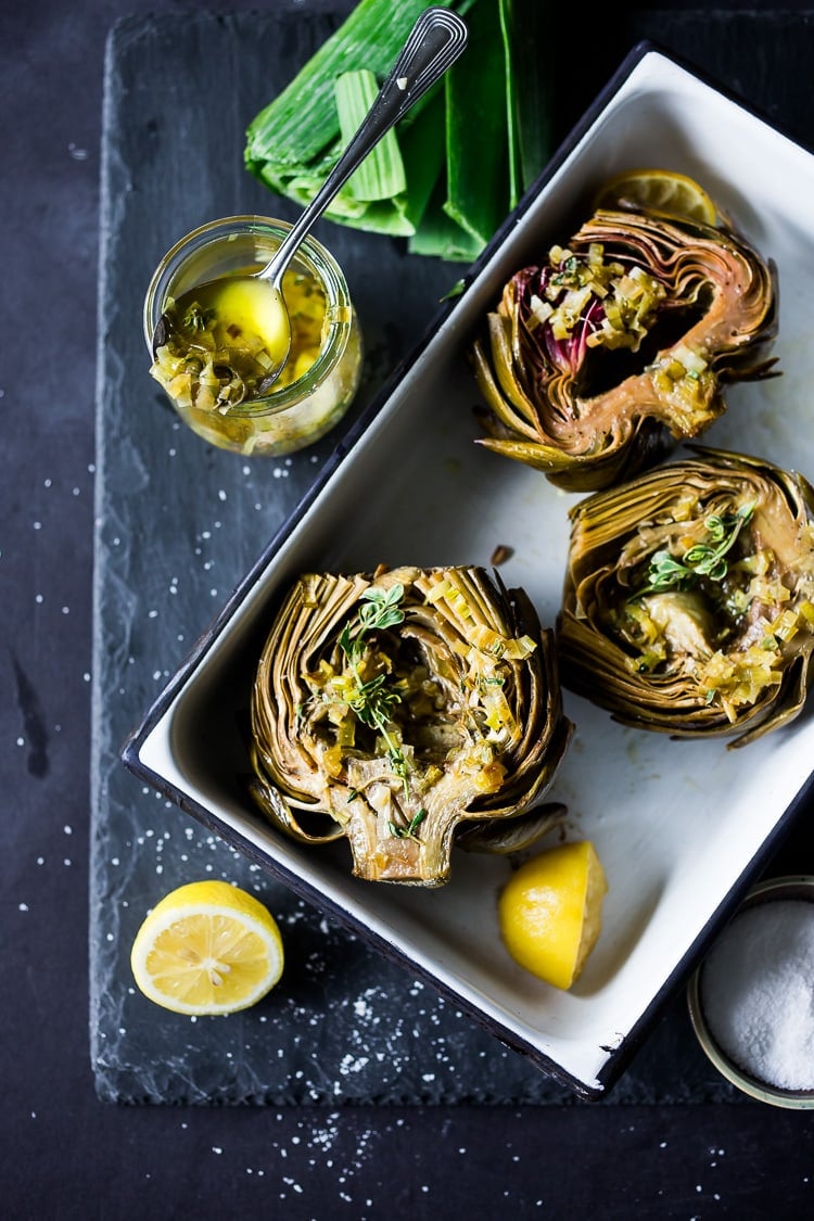 How to roast Artichokes! Roasted Artichokes with Lemony Leek dressing - a healthy vegan way to cook and serve our favorite spring vegetable! #artichoke #artichokes #bakedartichokes #roastedartichokes #vegan #veganartichokesauce 