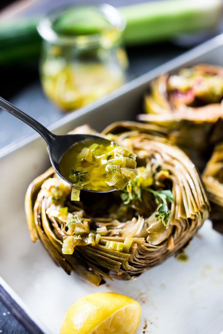 How to roast Artichokes! Roasted Artichokes with Lemony Leek dressing - a healthy vegan way to cook and serve our favorite spring vegetable! #artichoke #artichokes #bakedartichokes #roastedartichokes #vegan #veganartichokesauce 