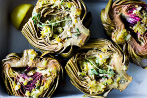 Roasted Artichokes with Lemony Leek dressing - a healthy vegan way to cook and serve our favorite spring vegetable! #artichoke #artichokes #bakedartichokes #roastedartichokes #vegan #veganartichokesauce