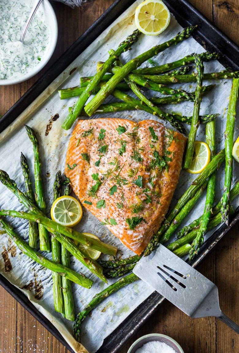 This recipe for Baked Salmon with Asparagus and Dill Sauce is so simple and easy, yet full of delicious flavor. Bake in the oven, on a sheet-pan in under 30 minutes! A healthy, spring-inspired dinner, perfect for busy weeknights when time is short. 