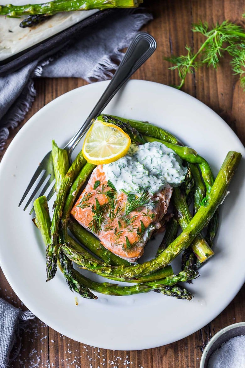 This recipe for Baked Salmon with Asparagus and Dill Sauce is so simple and easy, yet full of delicious flavor. Bake in the oven, on a sheet-pan in under 30 minutes! A healthy, spring-inspired dinner, perfect for busy weeknights when time is short. 