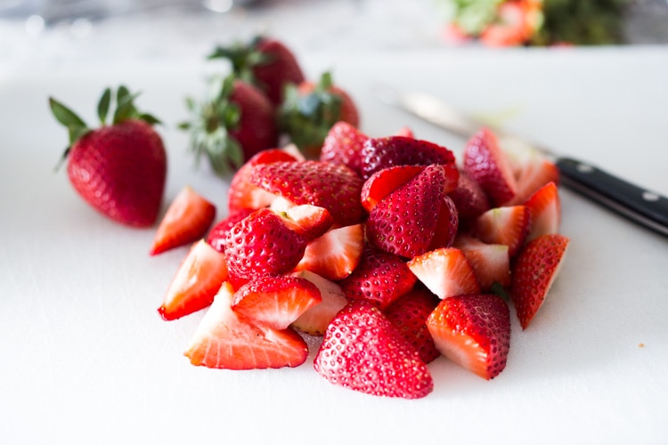 Baked French Toast (Vegan) with silken tofu, fresh berries orange zest and almonds. A healthy version of our favorite brunch recipe! Can be made ahead! #brunch #mothersday #veganbrunch #vegan #frenchtoast #feastingathome #healthybreakfast