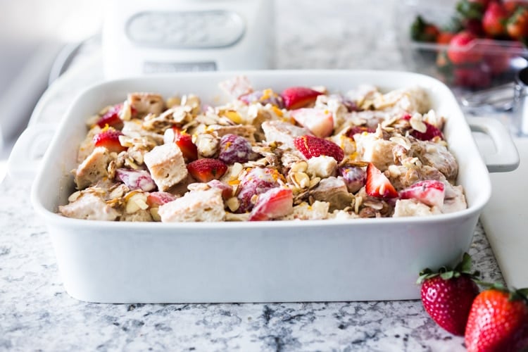 Baked French Toast (Vegan) with silken tofu, fresh berries orange zest and almonds. A healthy version of our favorite brunch recipe! Can be made ahead! #brunch #mothersday #veganbrunch #vegan #frenchtoast #feastingathome #healthybreakfast